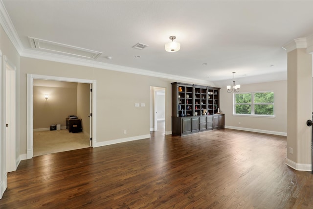 unfurnished living room featuring baseboards, ornamental molding, attic access, and dark wood-type flooring