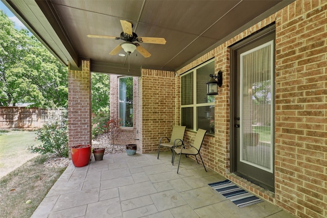 view of patio / terrace featuring fence and ceiling fan