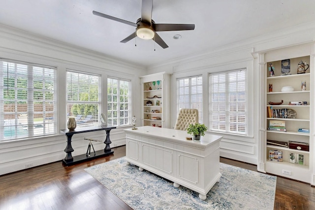 home office featuring a ceiling fan, dark wood-style flooring, a healthy amount of sunlight, and ornamental molding