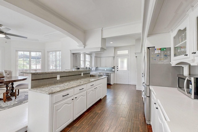 kitchen featuring white cabinetry, stainless steel microwave, ceiling fan, and dark wood-type flooring