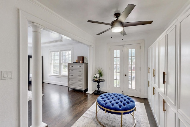 foyer featuring ceiling fan, decorative columns, dark wood-style flooring, crown molding, and baseboards