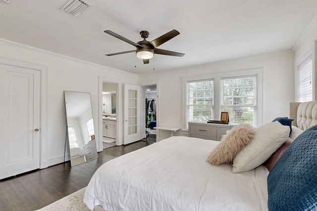 bedroom with multiple windows, ornamental molding, dark wood finished floors, and visible vents