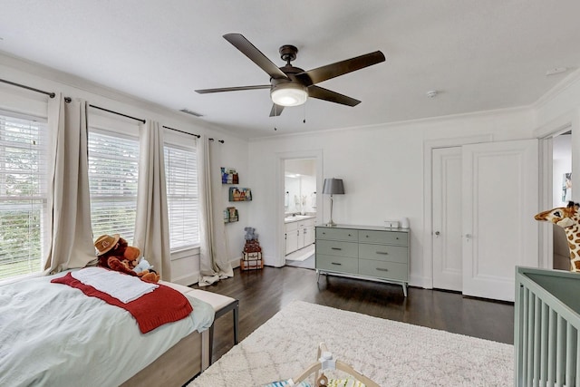 bedroom featuring crown molding, connected bathroom, a ceiling fan, visible vents, and dark wood-style floors