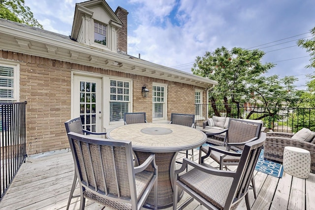 wooden deck featuring an outdoor hangout area, fence, and outdoor dining space
