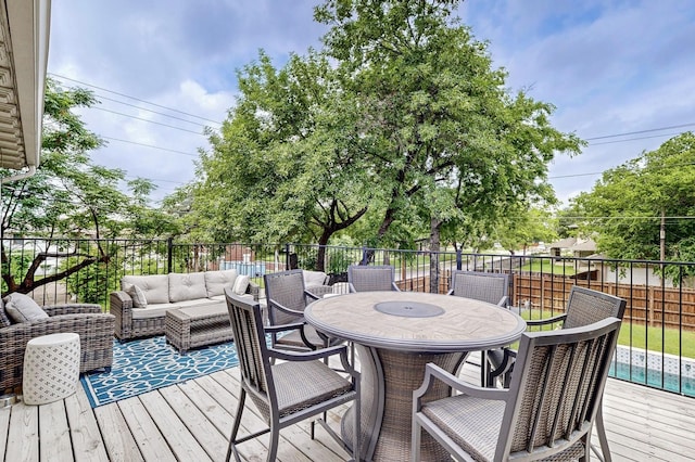 wooden deck featuring an outdoor hangout area, fence, and outdoor dining area