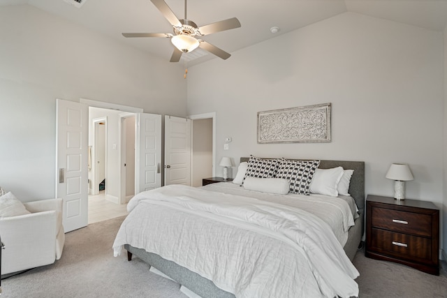 bedroom with carpet floors, a ceiling fan, and high vaulted ceiling