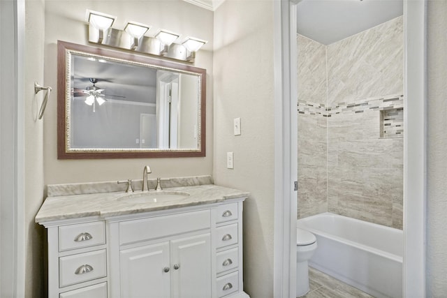 full bath featuring vanity, ceiling fan, bathtub / shower combination, and toilet
