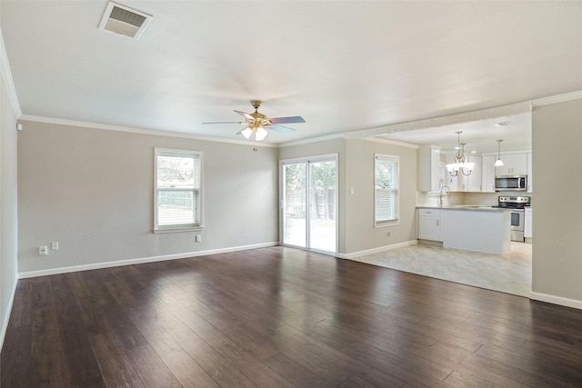 unfurnished living room featuring visible vents, ornamental molding, ceiling fan with notable chandelier, and wood finished floors