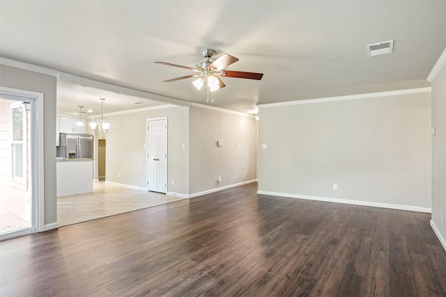 unfurnished living room featuring baseboards, ceiling fan with notable chandelier, dark wood-style flooring, and visible vents
