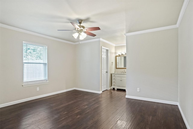 unfurnished bedroom featuring ornamental molding, baseboards, ceiling fan, dark wood-style floors, and connected bathroom