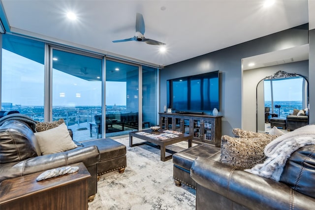 living area with a ceiling fan, a wall of windows, and recessed lighting