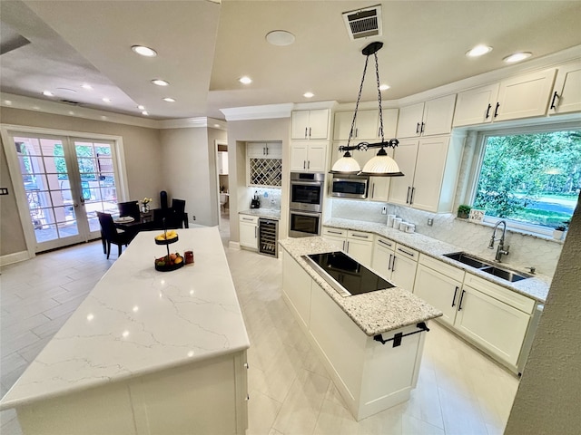 2025 Breaker Ln, Flower Mound, TX 75022 - kitchen with a center island, a sink, appliances with stainless steel finishes, and backsplash