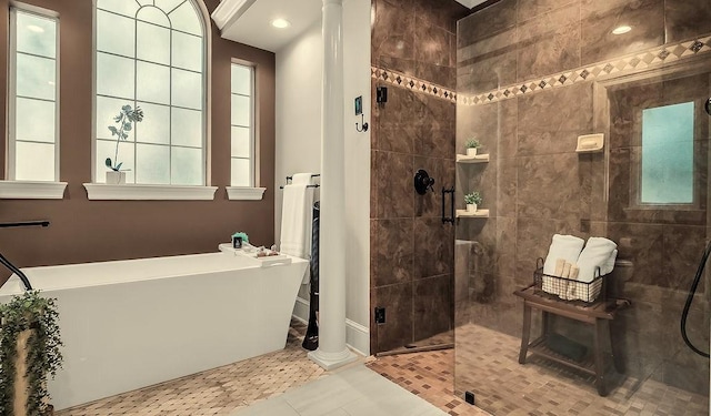 2025 Breaker Ln, Flower Mound, TX 75022 - bathroom with a walk in shower, baseboards, tile patterned floors, a soaking tub, and ornate columns