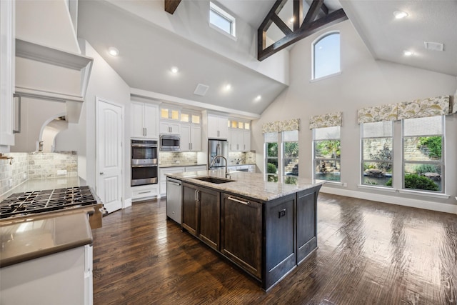 6380 Forefront Ave, Frisco, TX 75036 - kitchen featuring stainless steel appliances, a sink, high vaulted ceiling, white cabinets, and backsplash