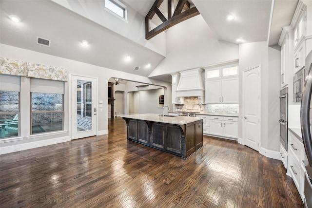 6380 Forefront Ave, Frisco, TX 75036 - kitchen with a sink, premium range hood, a breakfast bar area, dark wood-style flooring, and high vaulted ceiling