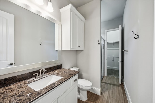 6380 Forefront Ave, Frisco, TX 75036 - bathroom with toilet, vanity, baseboards, and a shower