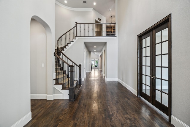 6380 Forefront Ave, Frisco, TX 75036 - foyer with french doors, wood finished floors, arched walkways, a high ceiling, and baseboards