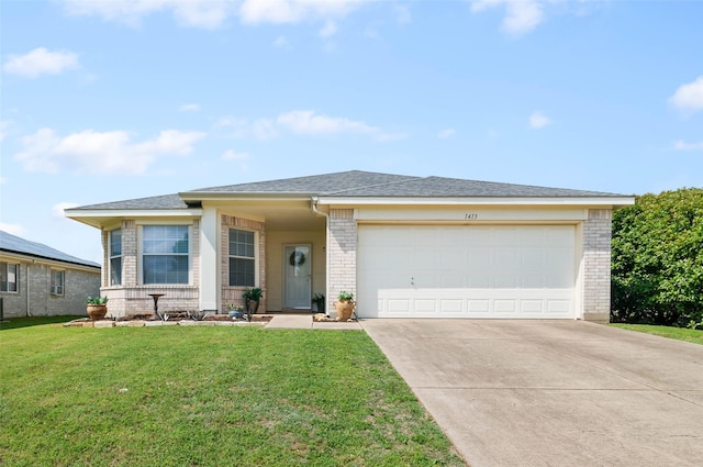 prairie-style home with a front lawn, brick siding, a shingled roof, an attached garage, and driveway