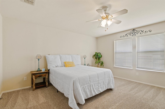 carpeted bedroom with baseboards, visible vents, and ceiling fan