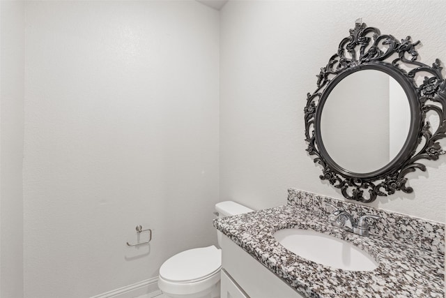 2021 Eva St, Grand Prairie, TX 75051 - bathroom featuring vanity, baseboards, and toilet