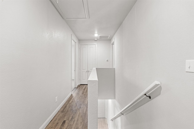 2021 Eva St, Grand Prairie, TX 75051 - hall with attic access, baseboards, an upstairs landing, wood finished floors, and visible vents