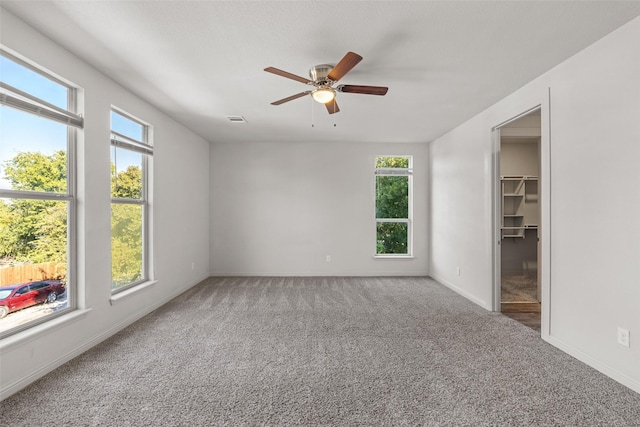2021 Eva St, Grand Prairie, TX 75051 - unfurnished bedroom with baseboards, a ceiling fan, carpet, and a spacious closet