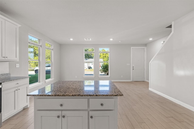 2021 Eva St, Grand Prairie, TX 75051 - kitchen with recessed lighting, light wood finished floors, dark stone countertops, and white cabinetry