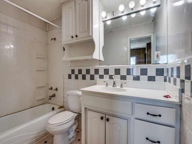 bathroom with vanity, toilet, shower / washtub combination, tile walls, and backsplash