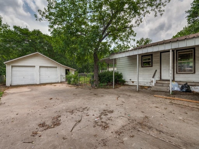 view of front of property with a garage and an outdoor structure