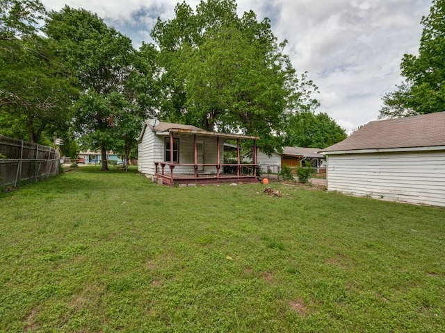 view of yard featuring fence and a wooden deck