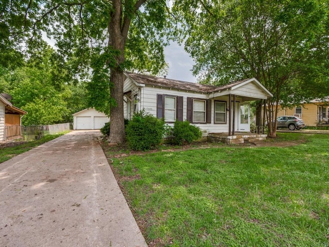 view of front of property with an outdoor structure, a garage, a front lawn, fence, and a porch