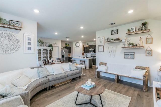 living area featuring recessed lighting, visible vents, and light wood-type flooring