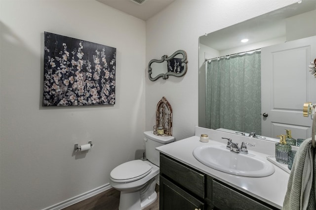 full bath with visible vents, wood finished floors, vanity, baseboards, and toilet