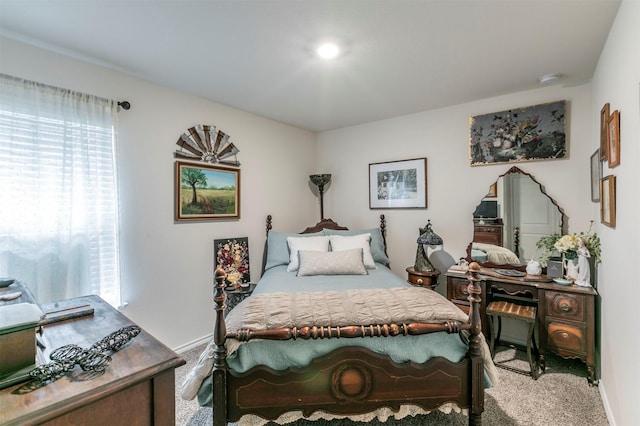 carpeted bedroom featuring baseboards