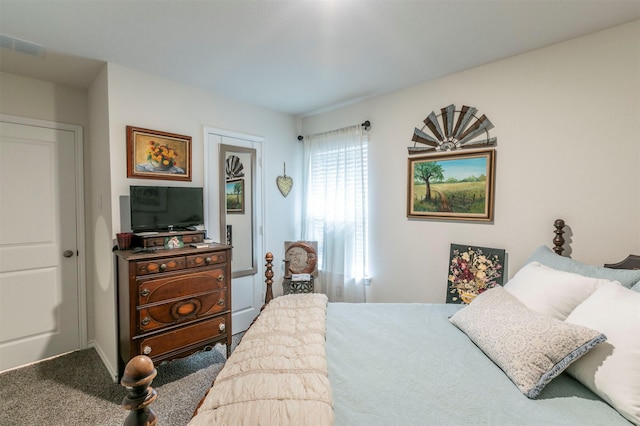 carpeted bedroom featuring visible vents