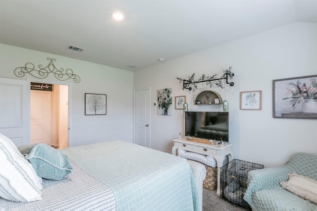 bedroom featuring visible vents, carpet, and vaulted ceiling