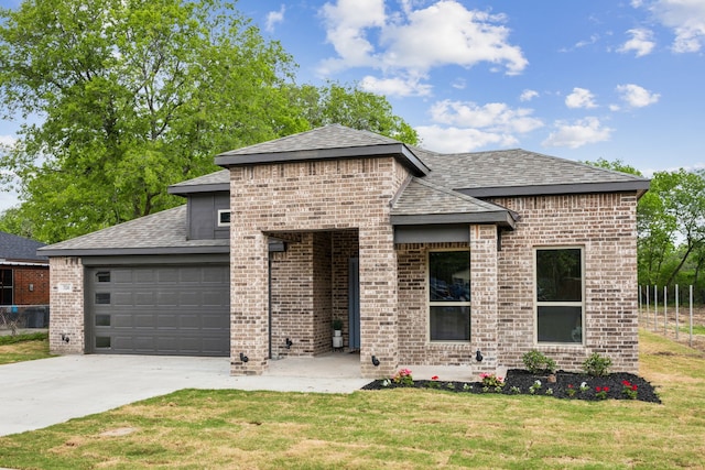 view of front of home featuring roof with shingles, a front lawn, brick siding, a garage, and driveway