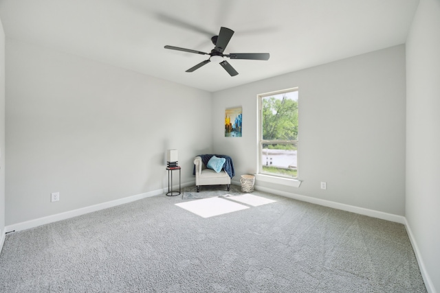 sitting room with ceiling fan, baseboards, and carpet