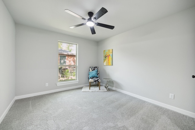 carpeted empty room featuring baseboards and a ceiling fan