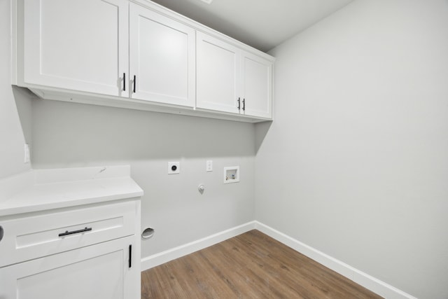 clothes washing area with cabinet space, washer hookup, baseboards, electric dryer hookup, and wood finished floors