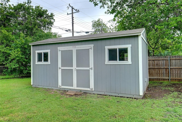 view of shed featuring fence