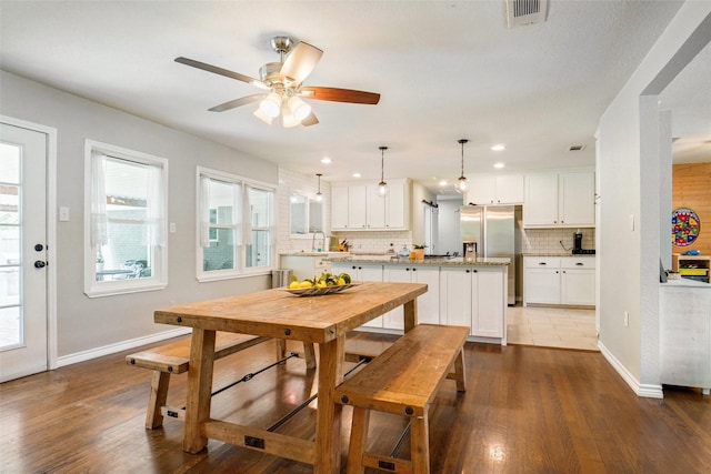 dining room with baseboards, a ceiling fan, dark wood-style flooring, and visible vents