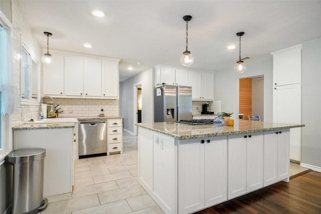 kitchen with appliances with stainless steel finishes, decorative backsplash, recessed lighting, and white cabinets