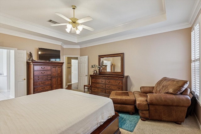 bedroom with crown molding, a raised ceiling, ceiling fan, and visible vents