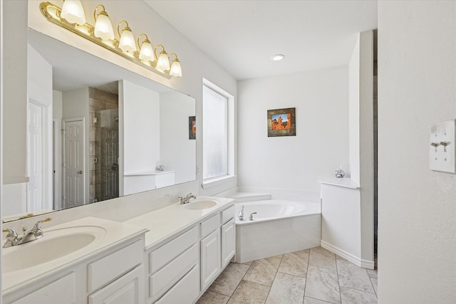 bathroom featuring a garden tub, a sink, a stall shower, and double vanity