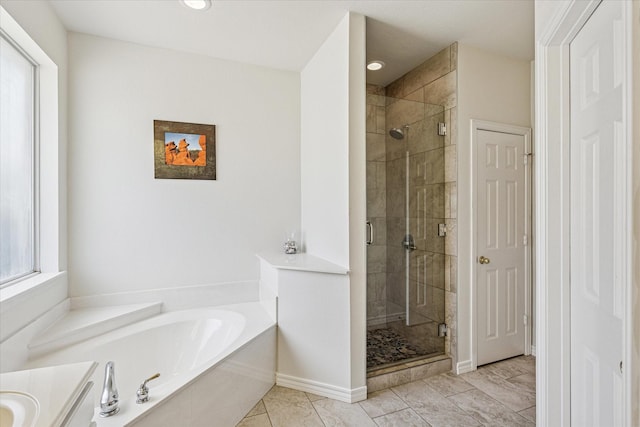 bathroom featuring a garden tub, recessed lighting, baseboards, and a shower stall