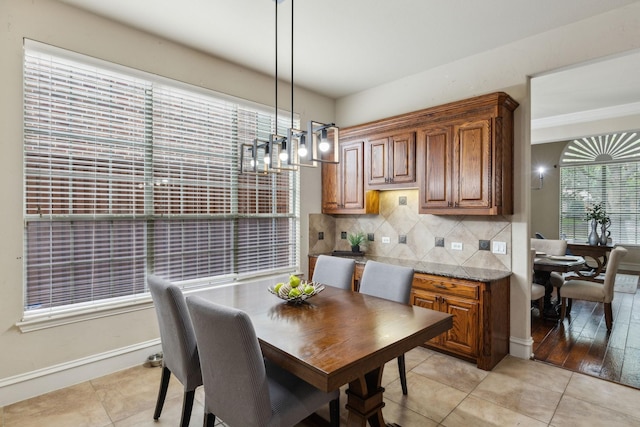 1016 Arches Park Dr, Allen, TX 75013 - dining space featuring a chandelier, baseboards, and light tile patterned floors