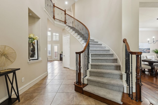 1016 Arches Park Dr, Allen, TX 75013 - tiled foyer entrance with a high ceiling, stairs, baseboards, and ornamental molding