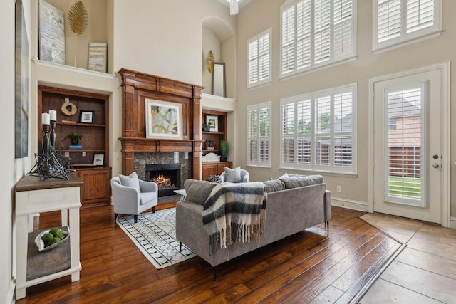 1016 Arches Park Dr, Allen, TX 75013 - living room with a high ceiling, a fireplace, hardwood / wood-style flooring, and baseboards