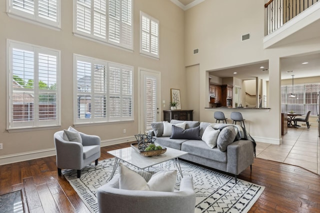 1016 Arches Park Dr, Allen, TX 75013 - living room featuring plenty of natural light, baseboards, hardwood / wood-style floors, crown molding, and a high ceiling